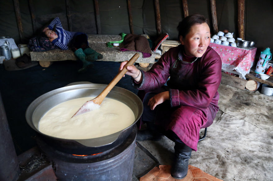 Bolorma is boiling milk to make cheese that the family needs to feed themselves