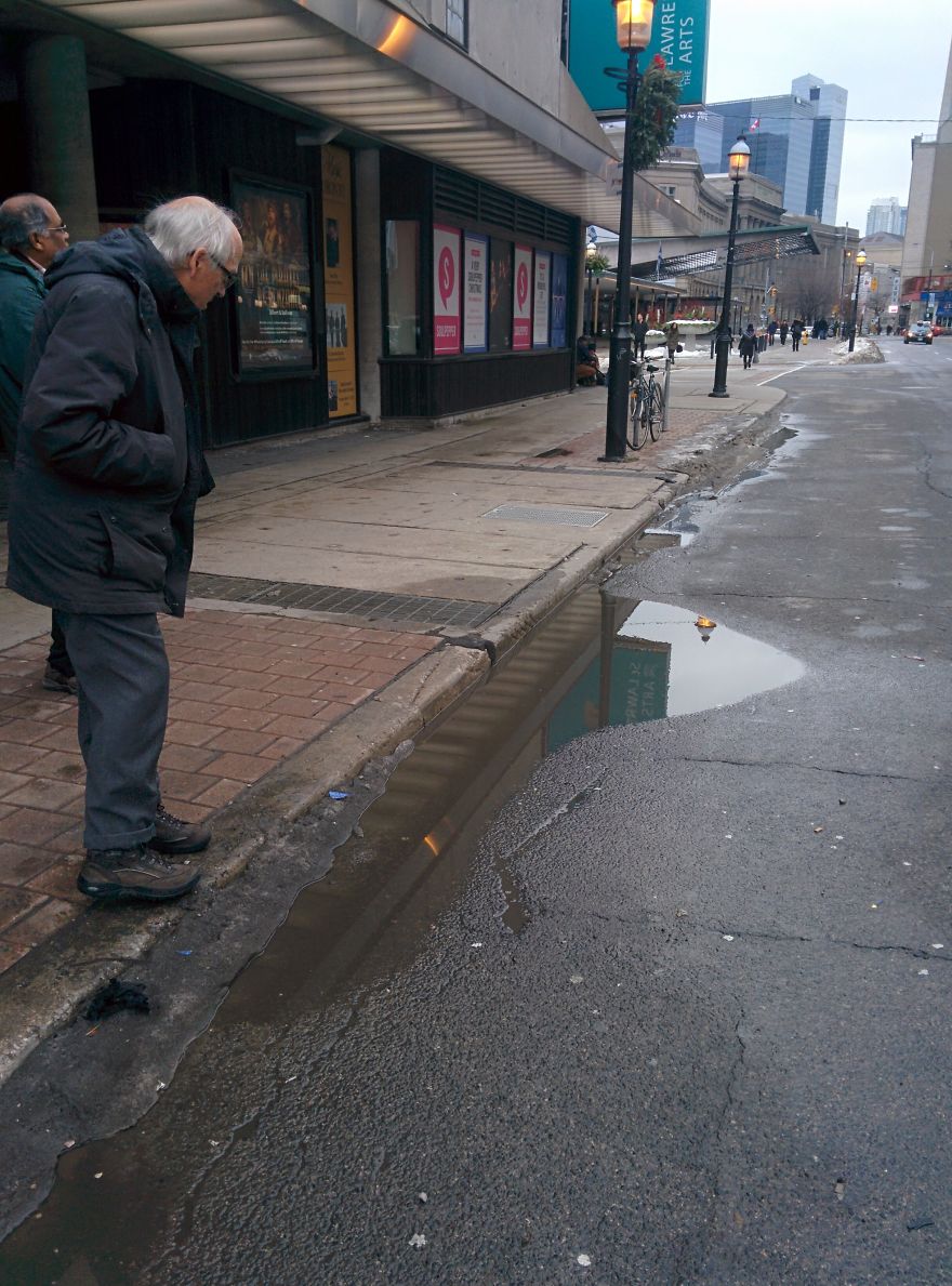 I Was Taking A Picture Of A Puddle In Toronto Until I Was Approched By Two Different Strangers And This Happened