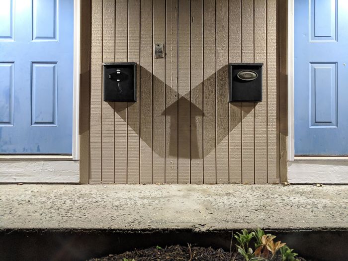The Shadow Of Two Mailboxes Makes A Perfect Up Arrow