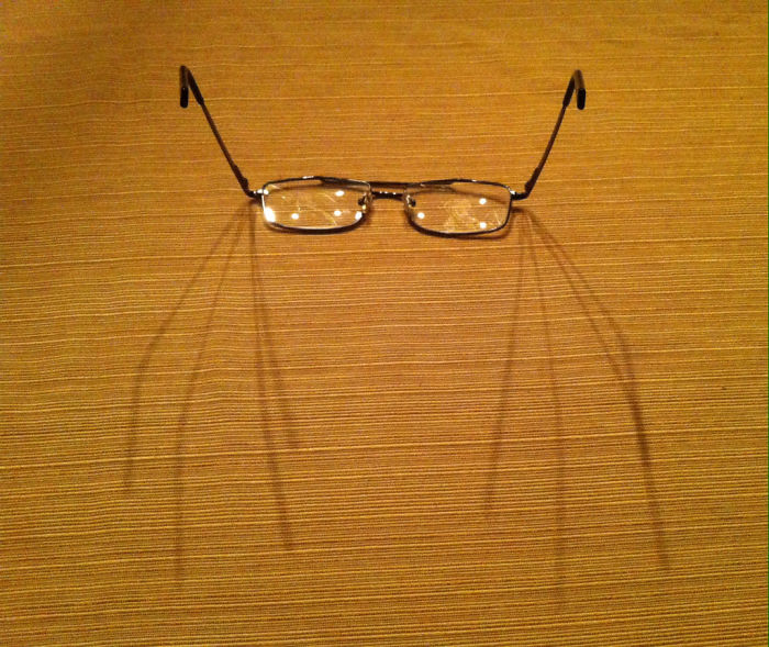 I Set My Glasses On The Table, And The Multiple Shadows Transformed Them Into A Spider