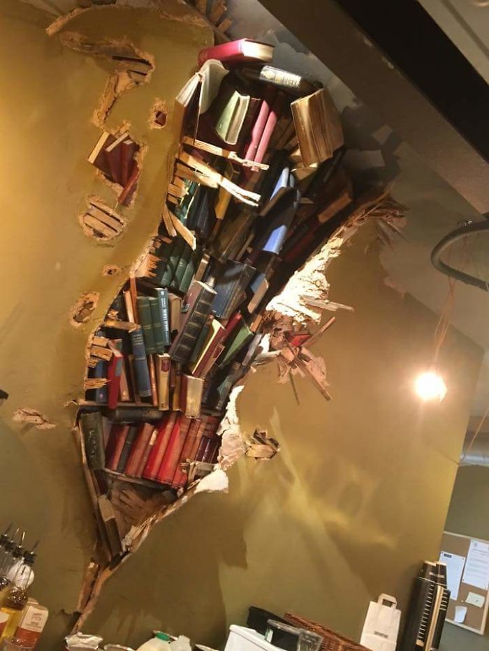This Coffee Shop Wall With Books Crashing Through
