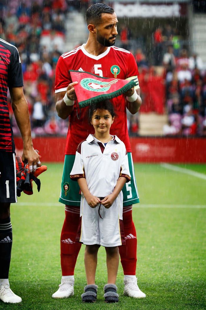 Moroccan Soccer Player Medhi Benatia Protecting A Little Girl From The Rain
