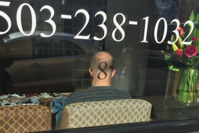 This Projection Of A Telephone Digit Onto The Back Of A Man's Head