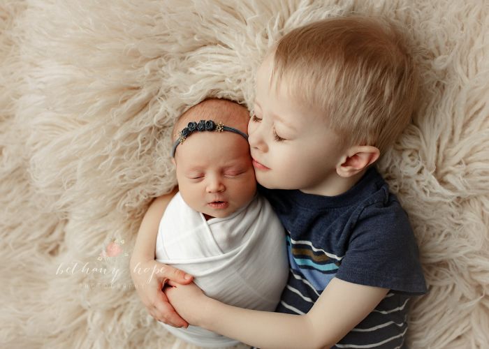  photograph newborn babies their siblings 