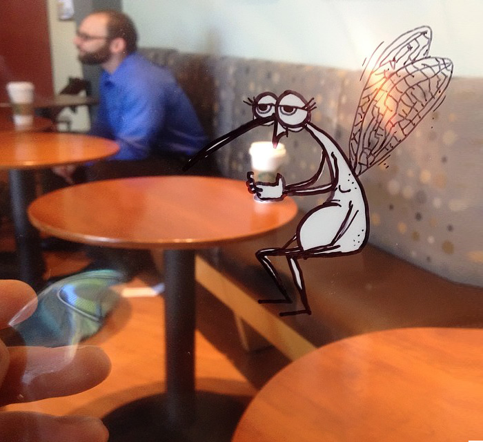 Artist Inserts Cartoons Into Real-World Situations By Doodling Them On Transparency Sheets