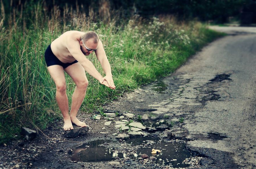 Friends Take Funny Pothole Photos To Draw Government's Attention To Poor Road Conditions In Kaunas