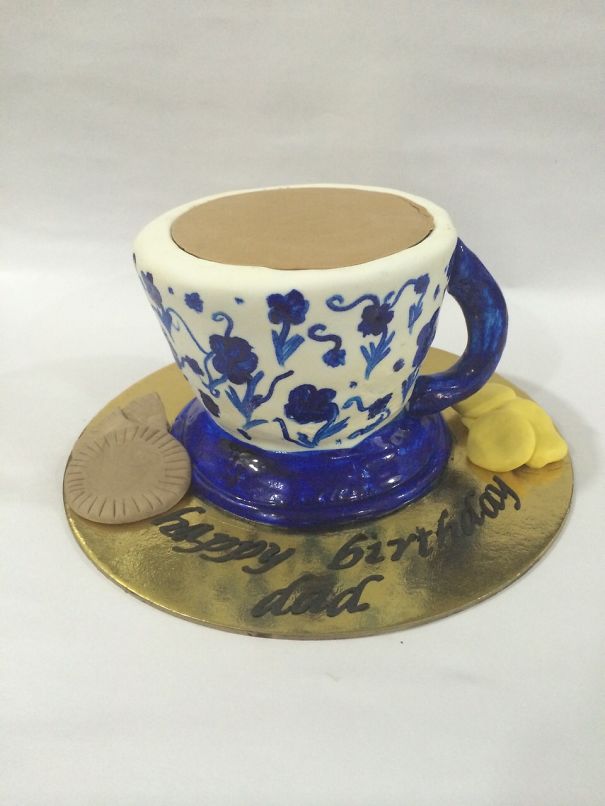 A Tea Cup Cake With Biscuits And Cookies