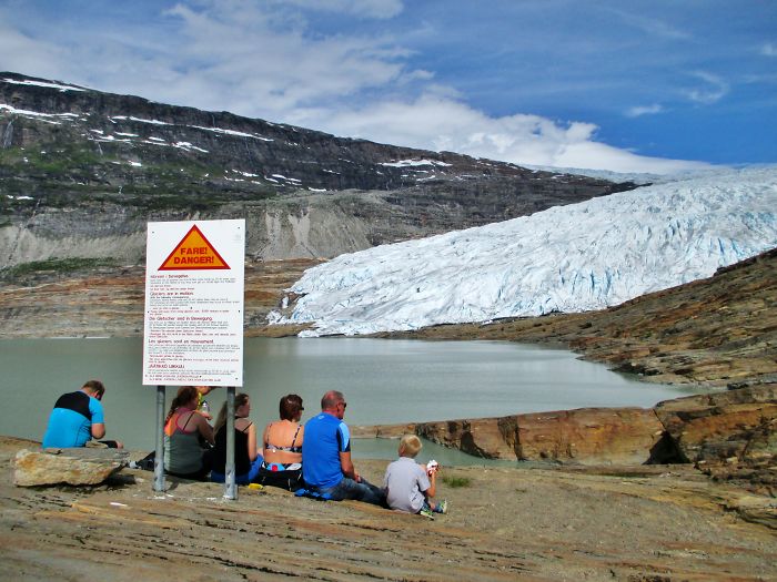 People Looking At Melting Ice. Svartisen Glacier.