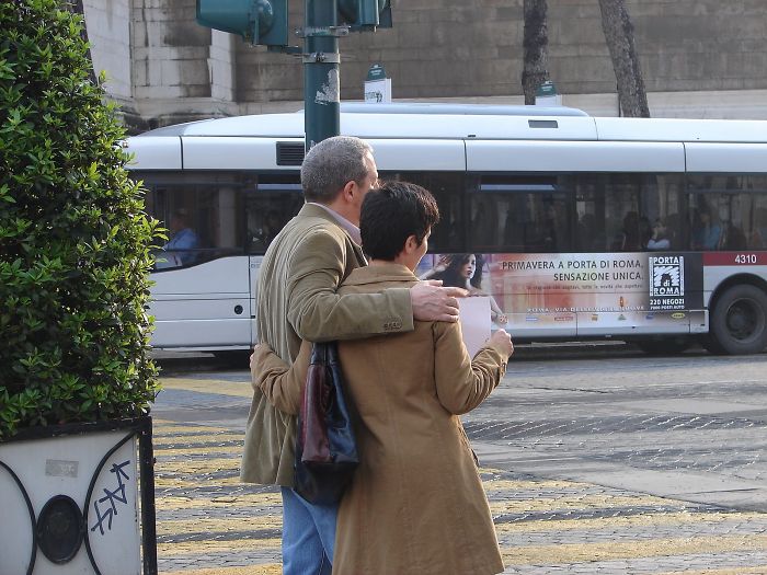 The Couple Is Posing For Picture In Rome, Italy