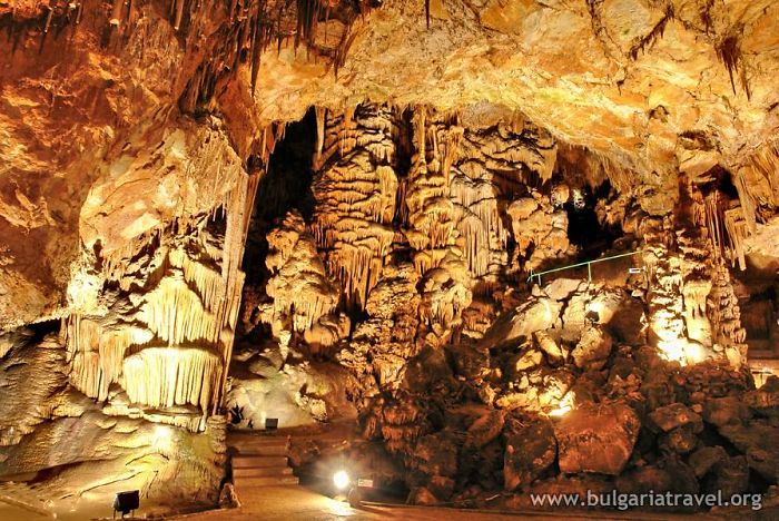 Beautiful caves from around the world with illuminated stalactites and stalagmites inside a large natural cave chamber.