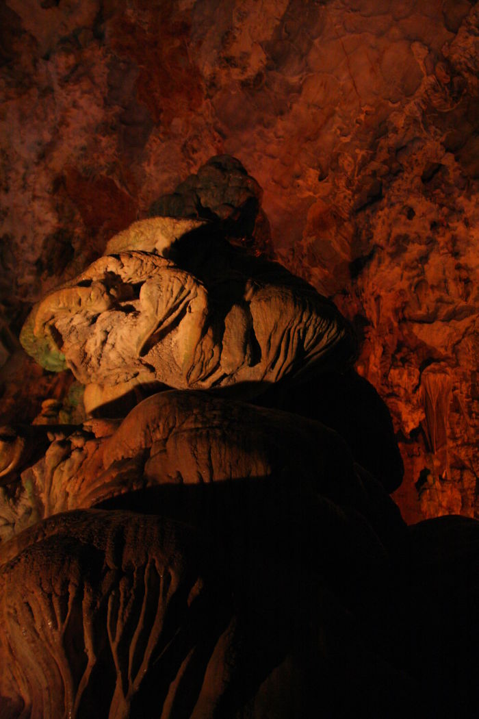 Beautiful cave formations illuminated inside a dark cavern showcasing natural textures and colors of caves around the world