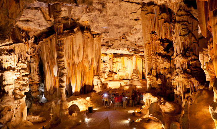 Beautiful caves interior with stalactites and stalagmites, illuminated and showcasing natural formations around the world.