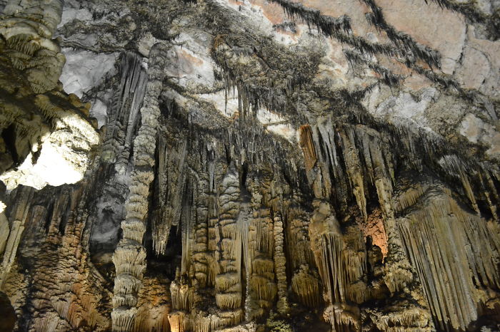 Interior view of beautiful caves showcasing stalactites and stalagmites in a natural underground formation.