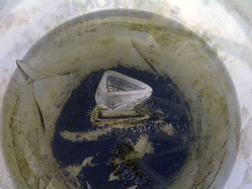 Water Freezing In A Bucket Created A Triangular Vase