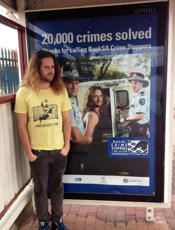 Man standing near poster of man that looks like him