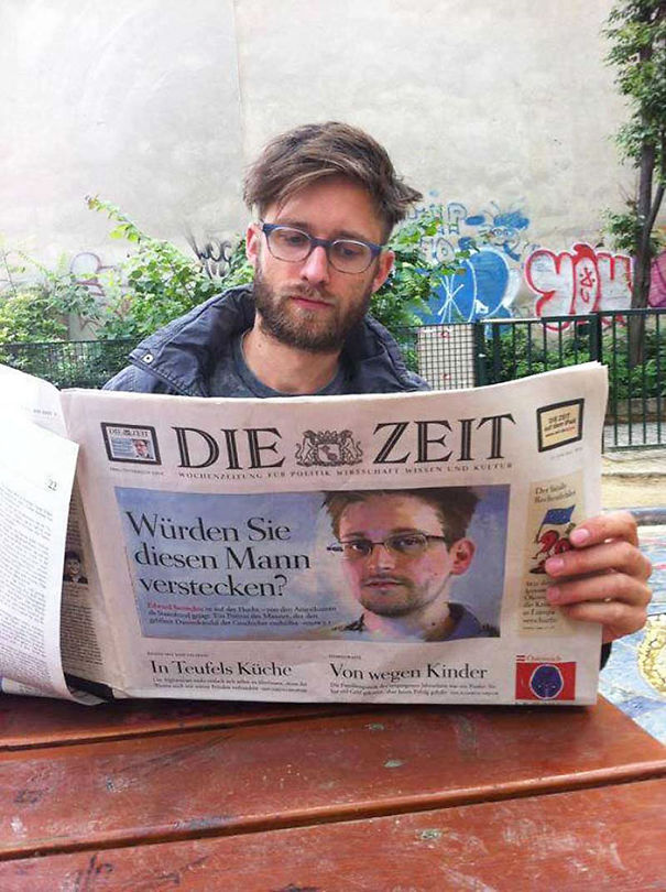 Person reading newspaper and there is man's face similar to reader in a newspaper