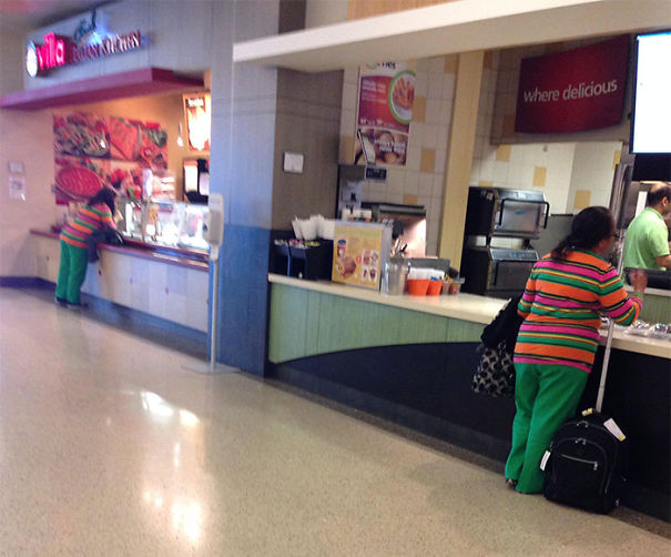 Two womens buying food and wearing same clothes