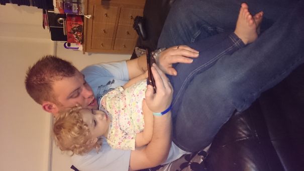 Watching Her Favourite Programme On Daddy's Phone.
