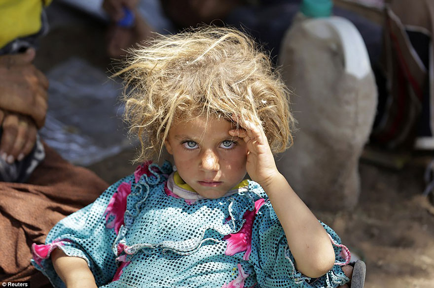 A Girl From The Minority Yazidi Sect Rests At The Iraqi-Syrian Border