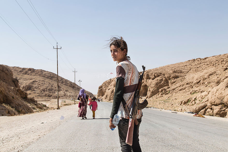 Yezidi Girl Carries An Assault Rifle To Protect Her Family Against ISIS