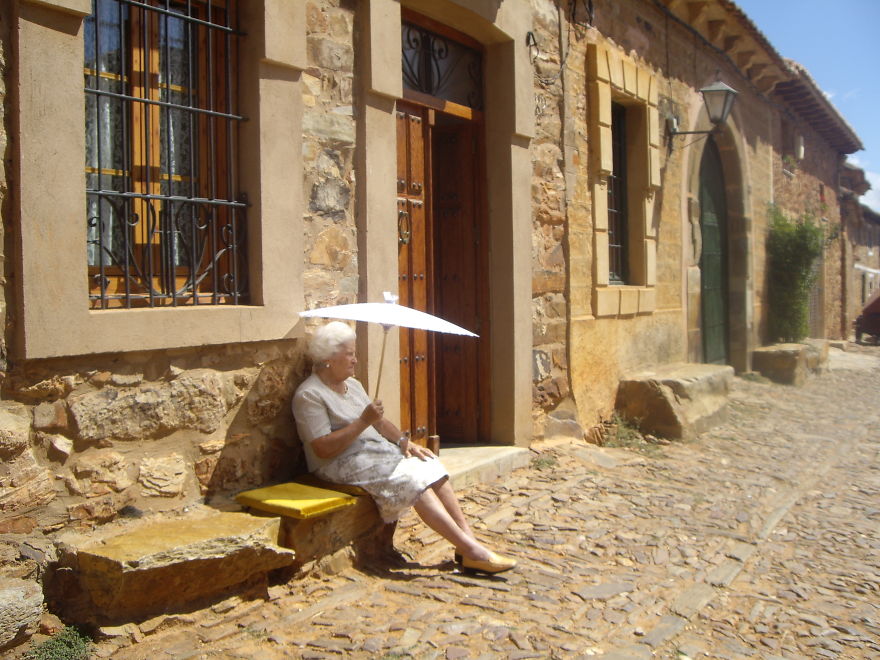 An Old Woman Sittng In The Afternoon Sun, Near Ponferrada, Spain.
