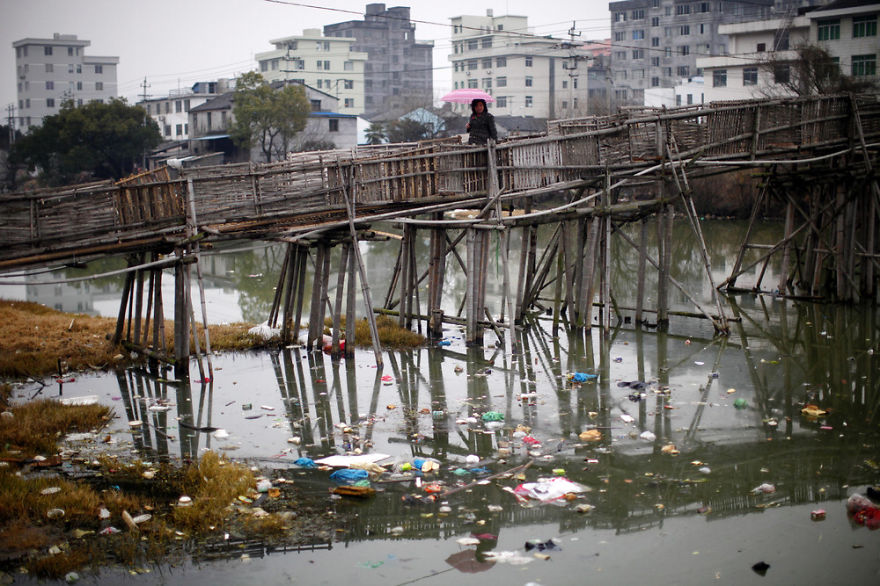 Woman Walks On Bridge Over Polluted River, Wenzhou, Zhejiang Province