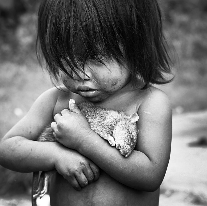 Little Guarani Girl Holds On Tight To A Dead Rat