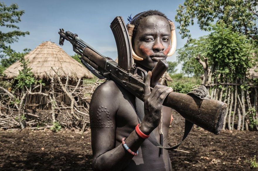 A Young Mursi Man Holds An Ak-47, Marenke, Omo Valley, Ethiopia
