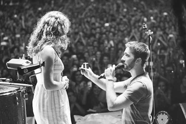 Proposing On Stage During A Concert Of A Favorite Band. "I was shaking and couldn’t stop smiling. I listened while the man of my dreams knelt and proposed to me, echoed by the cheers of 7000 supporters."
