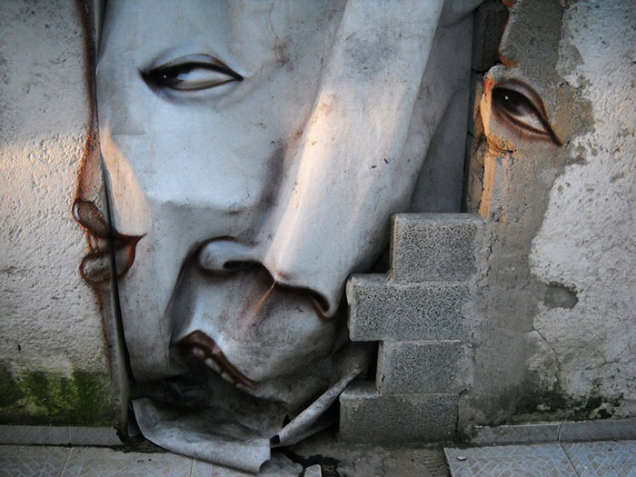Street Artist Turns Rocks And Ruins Into Faces