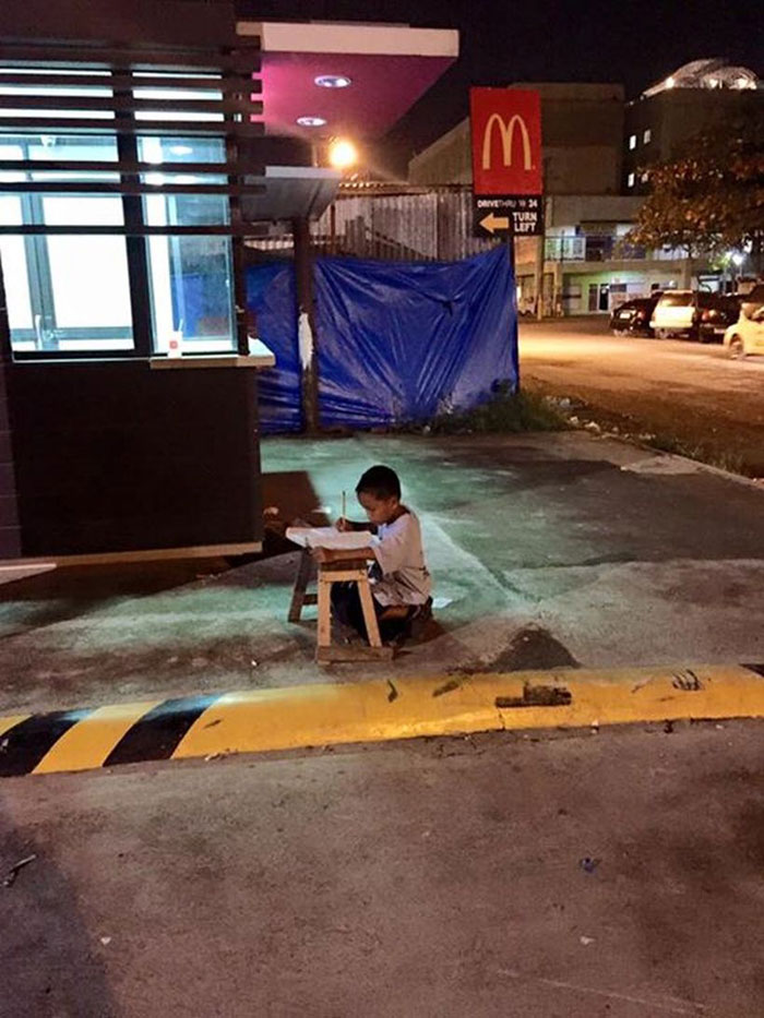 Homeless Boy Does His Homework Using The Light From A Local McDonald's