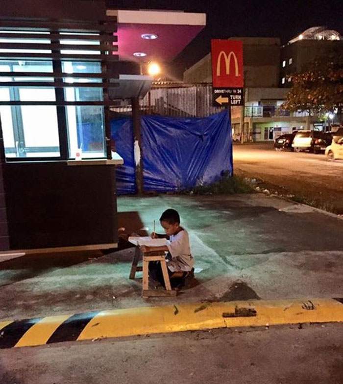 Homeless Boy Does His Homework Using The Light From A Local McDonald’s