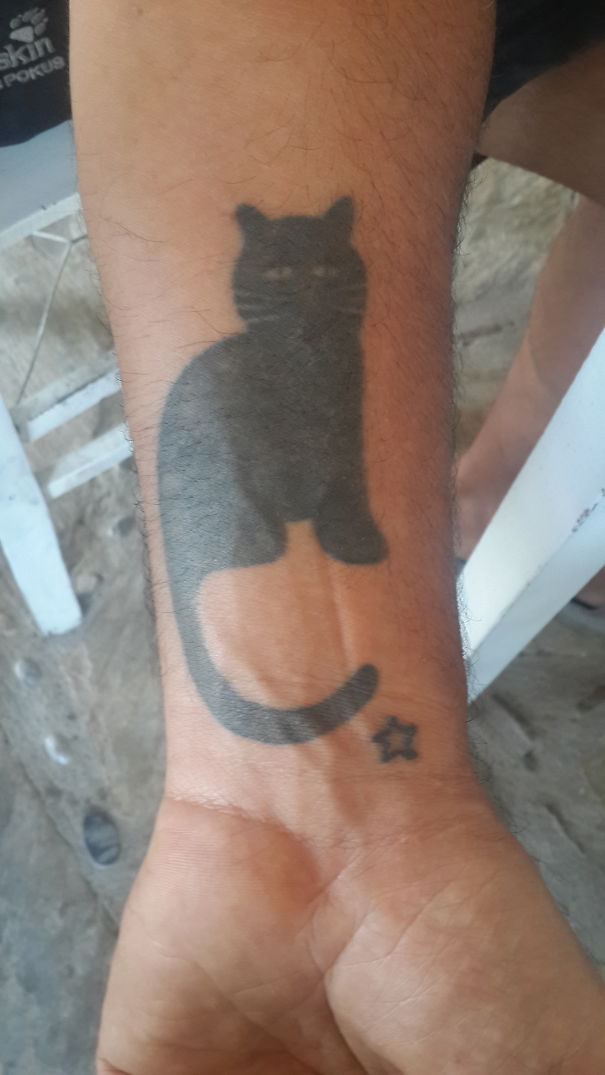 Black cat and a star wrist tattoo
