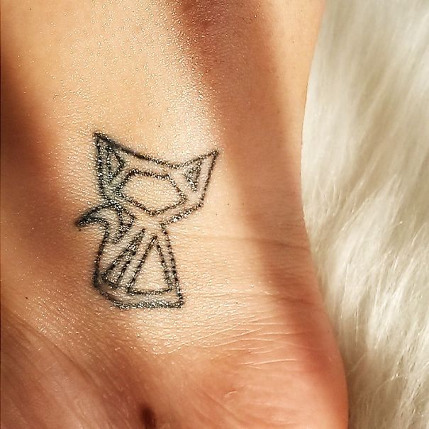 Geometrical cat wrist tattoo