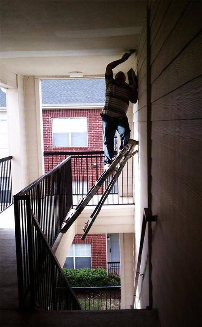 Man perilously balancing a ladder over a stairway, highlighting why women often live longer than men.