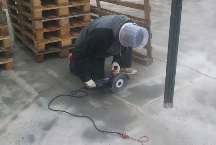 Man using power tool without proper safety gear, illustrating reasons why women live longer than men.