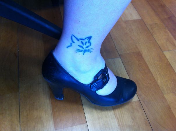 Cat's face ankle tattoo