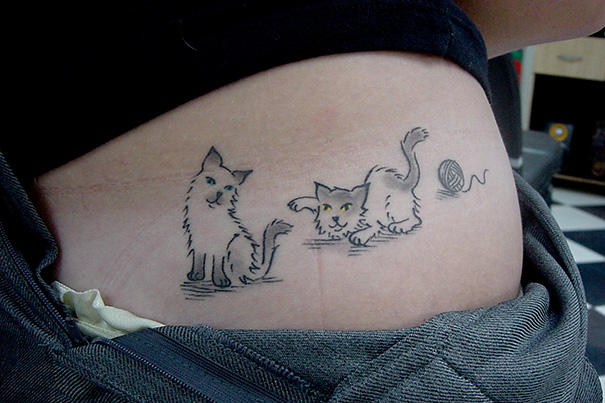 Two cats playing tattoo