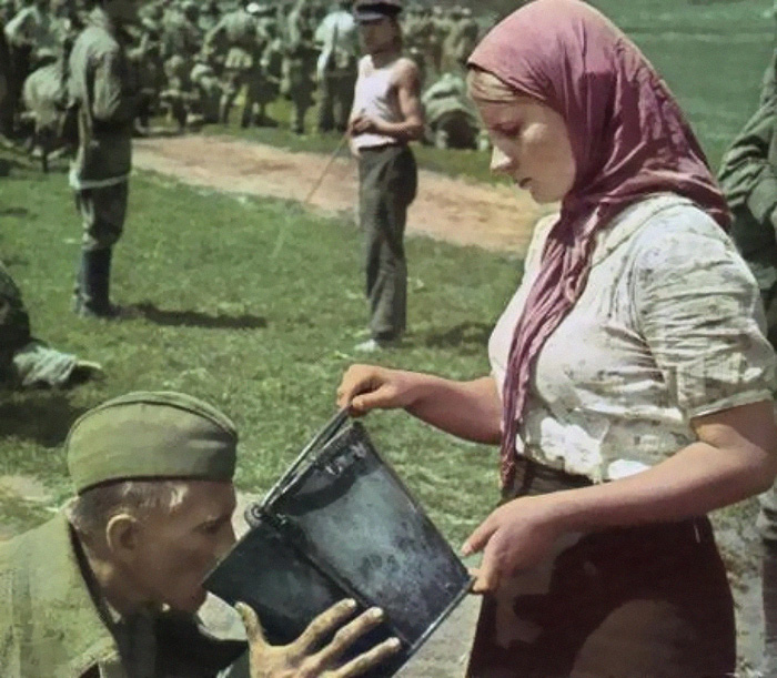 Soviet Soldier Is Given Water By A Ukrainian Woman After Being Captured During The Battle For Kiev (1941)