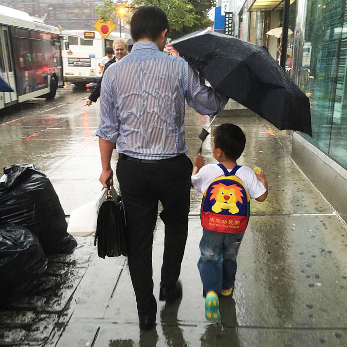 Soaked Dad Protecting His Schoolboy From Rain Shows What Parenting Is