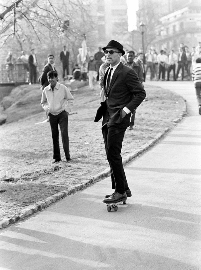 A Man In A Suit And Sunglasses Rides A Skateboard Down A Hill Path In Central Park, New York (1965)