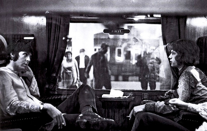 Paul McCartney Of The Beatles And Mick Jagger Of The Rolling Stones Sit Opposite Each Other On A Train At Euston Station (1967)