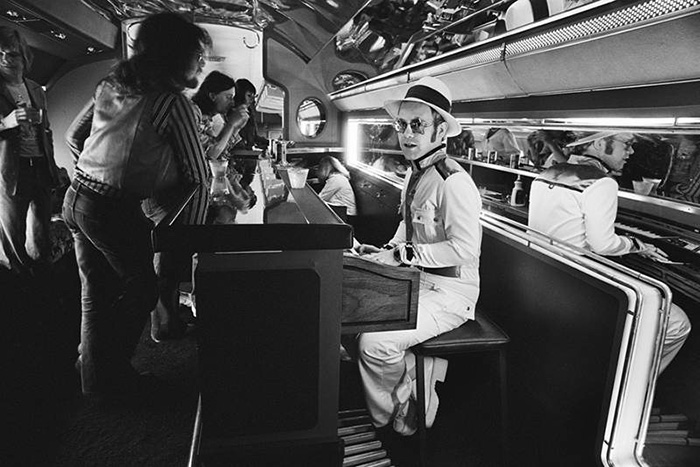 Elton John At His Piano Bar Aboard His Private Jet (1974)