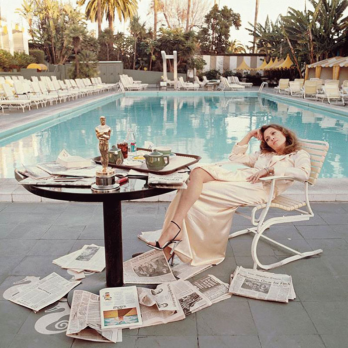 American Actress Faye Dunaway Takes Breakfast By The Pool With The Day's Newspapers (1977)