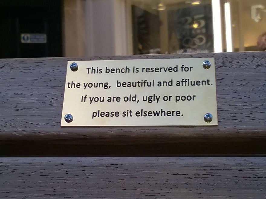 City Council Searches For Pranksters Who Added Funny Signs To Park Benches