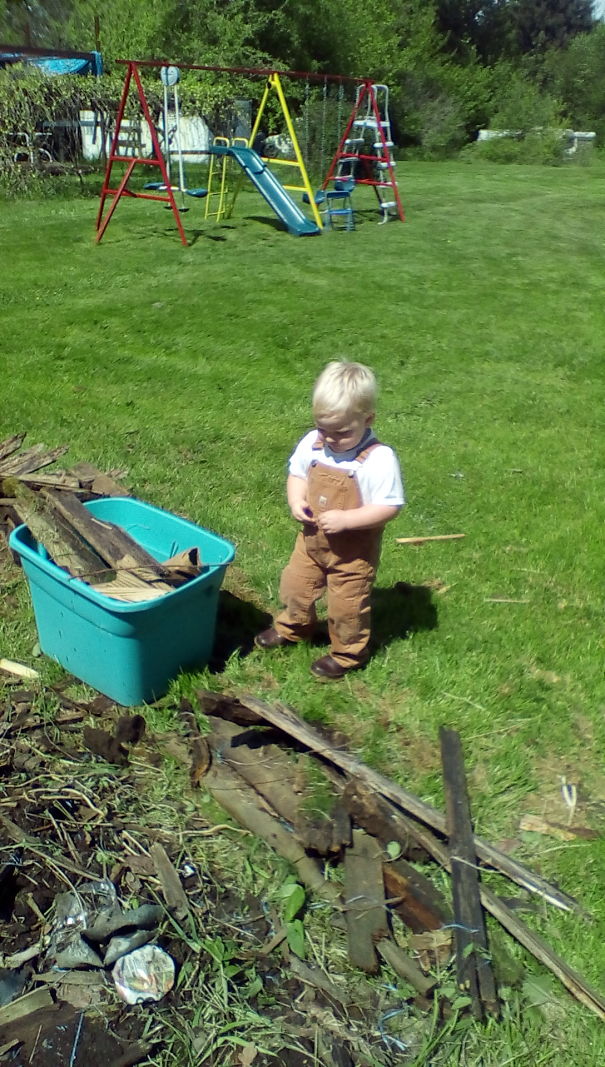 My 2 Yr Old Son Picking Loose Wood Up Around The Yard So His Papa Can Mow.