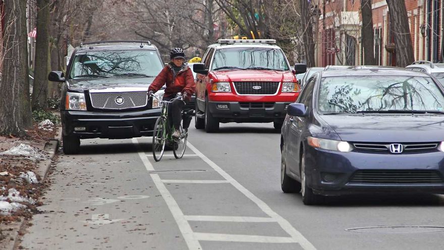 A Man Drives Down A Bike Trail