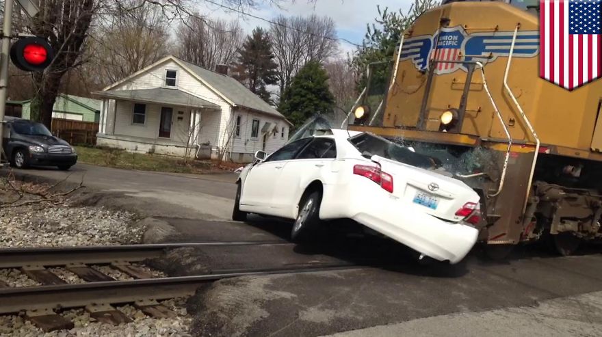 Woman Drives Car Onto Railroad Tracks