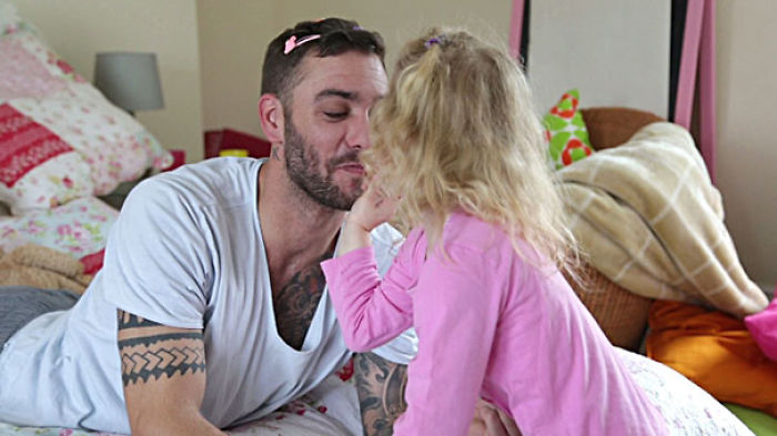 Little Girl Applying Make-Up To Her Daddy