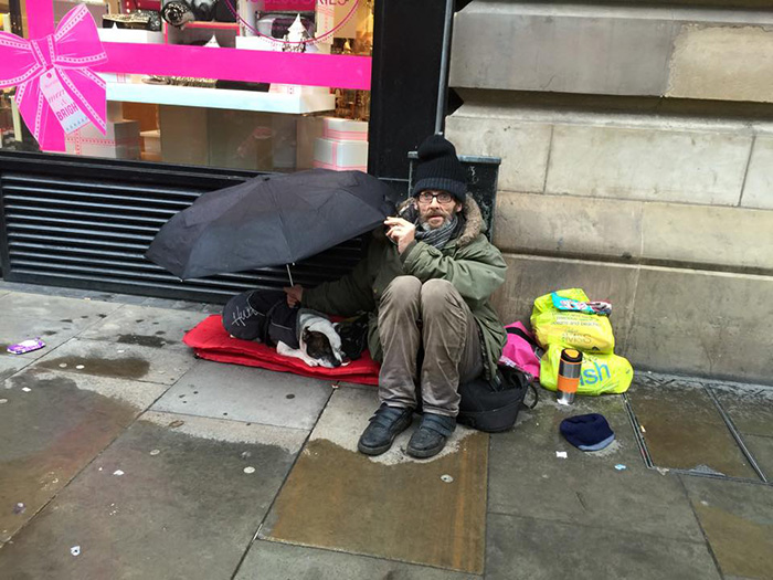 Dog Sleeps Under His Homeless Owner's Umbrella